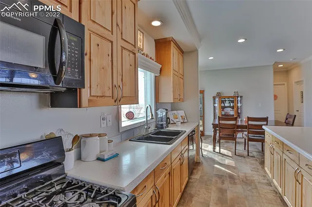 a living room with furniture a two couches and a dining table with kitchen view