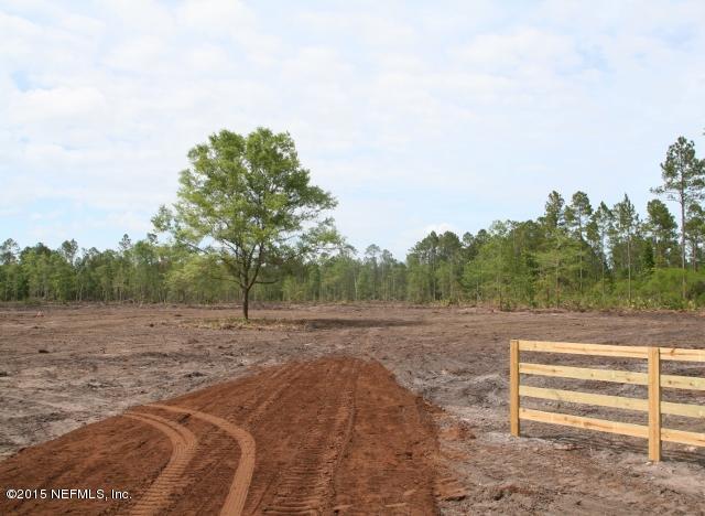 483 Randy Road Yulee, FL 32097 - Photo 2 of 6 a view of dirt road with trees