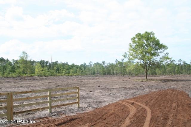 483 Randy Road Yulee, FL 32097 - Photo 3 of 6 a view of a field with wooden fence