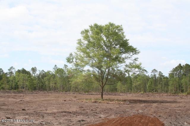 483 Randy Road Yulee, FL 32097 - Photo 4 of 6 a view of dirt field with trees