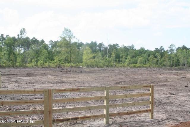 483 Randy Road Yulee, FL 32097 - Photo 5 of 6 a view of a dry yard with wooden fence