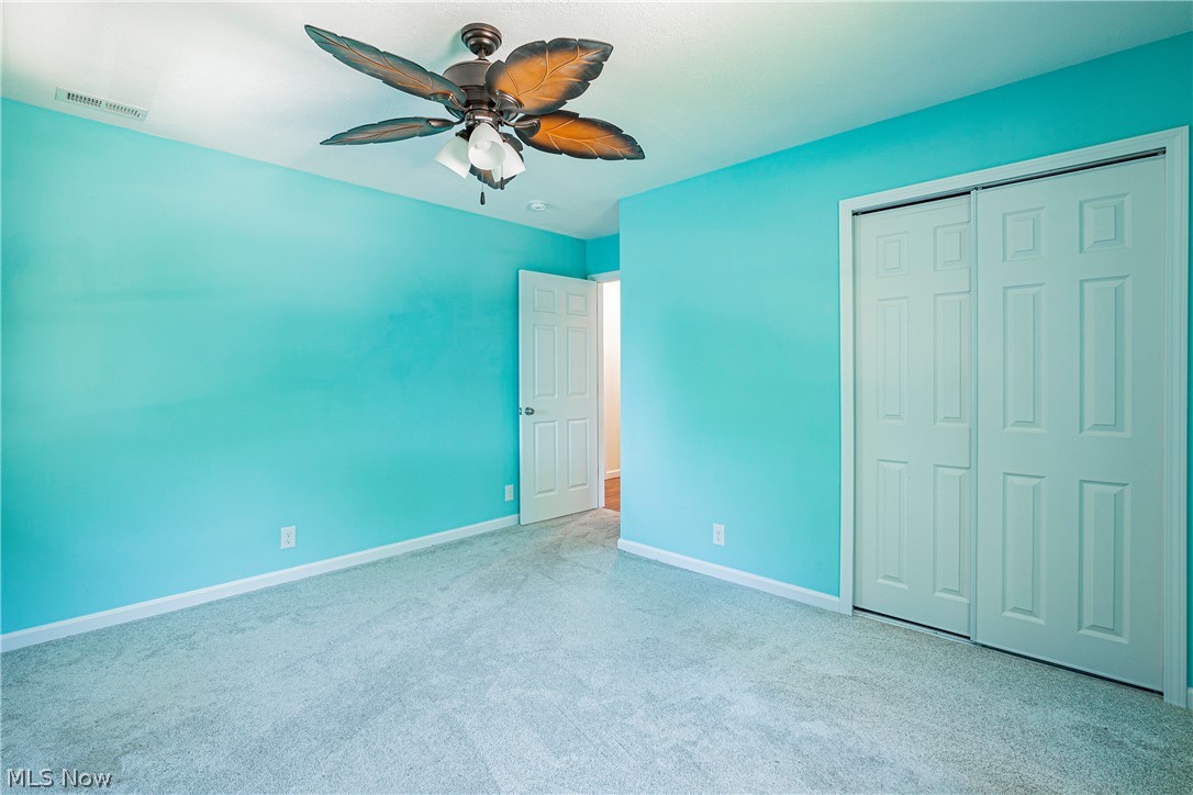 2055 Ganyard Road Akron, OH 44313 - Photo 25 of 49 Unfurnished bedroom featuring carpet, a closet, and ceiling fan