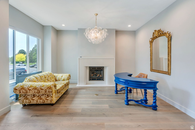 250 South Main Street, Unit 10 Alpine, UT 84004 - Photo 9 of 29 Spacious room featuring light wood-finish flooring, a contemporary fireplace with a fluted surround, large windows, recessed lighting, and a bubble chandelier