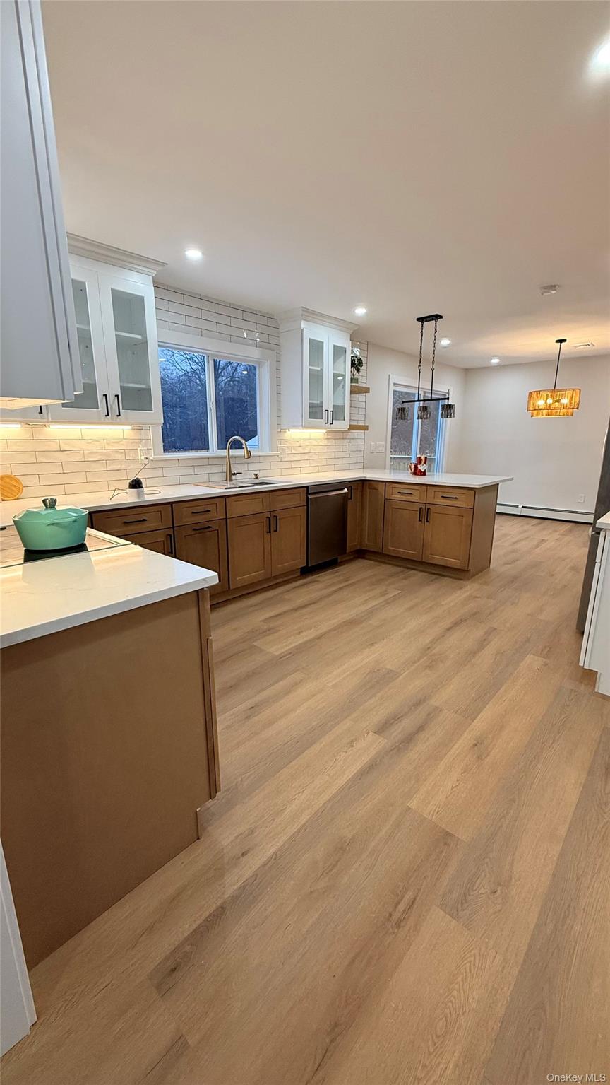 94 Sally Lane Ridge, NY 11961 - Photo 11 of 17 a living room with stainless steel appliances kitchen island granite countertop a sink and cabinets