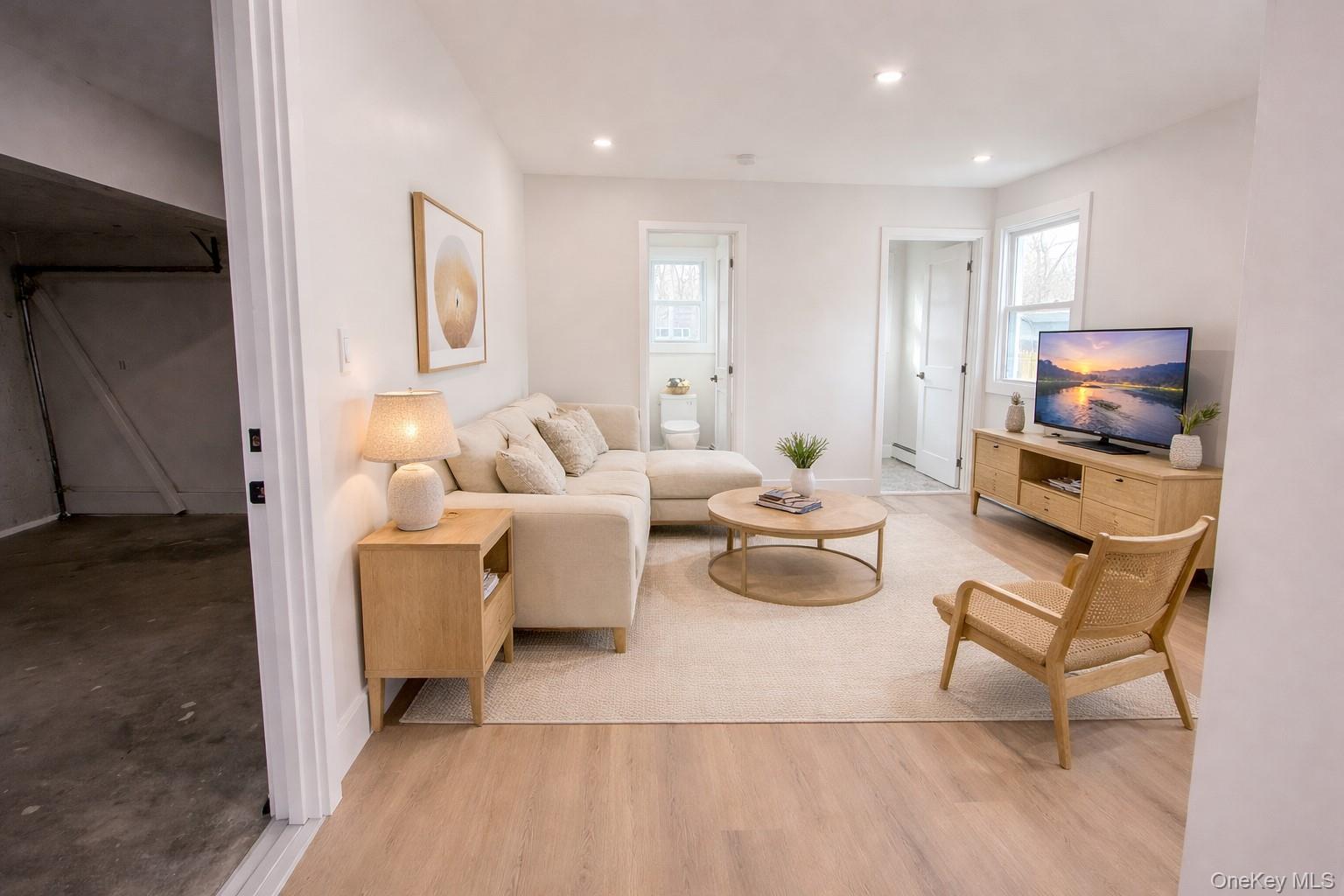 94 Sally Lane Ridge, NY 11961 - Photo 13 of 17 a living room with furniture and a flat screen tv