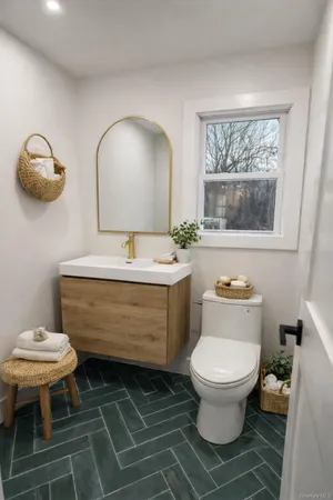 a bathroom with a toilet sink and mirror