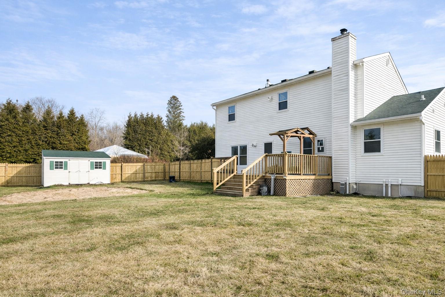 94 Sally Lane Ridge, NY 11961 - Photo 16 of 17 a view of a house with a yard