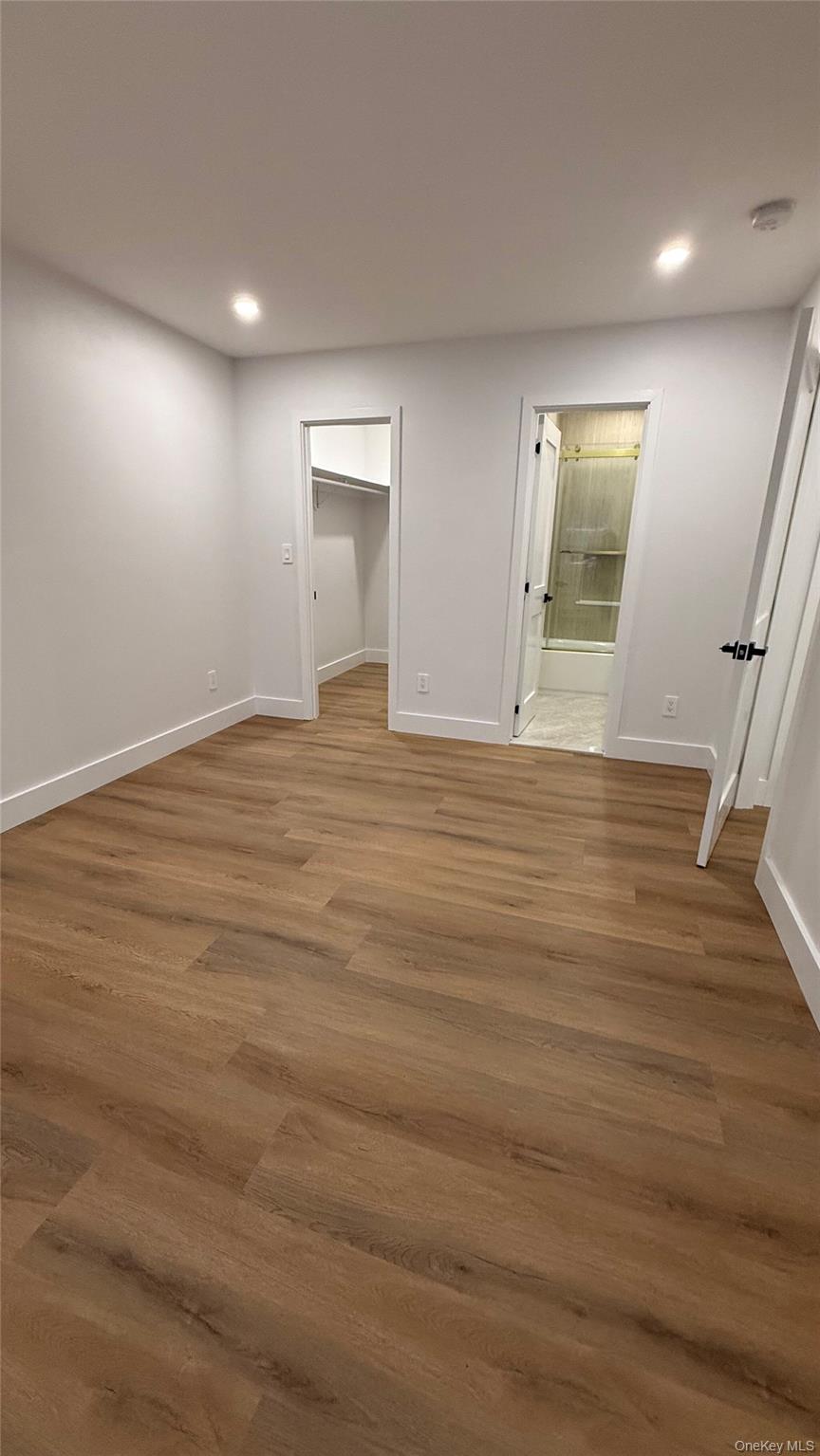 94 Sally Lane Ridge, NY 11961 - Photo 2 of 17 a view of an empty room with wooden floor and a window