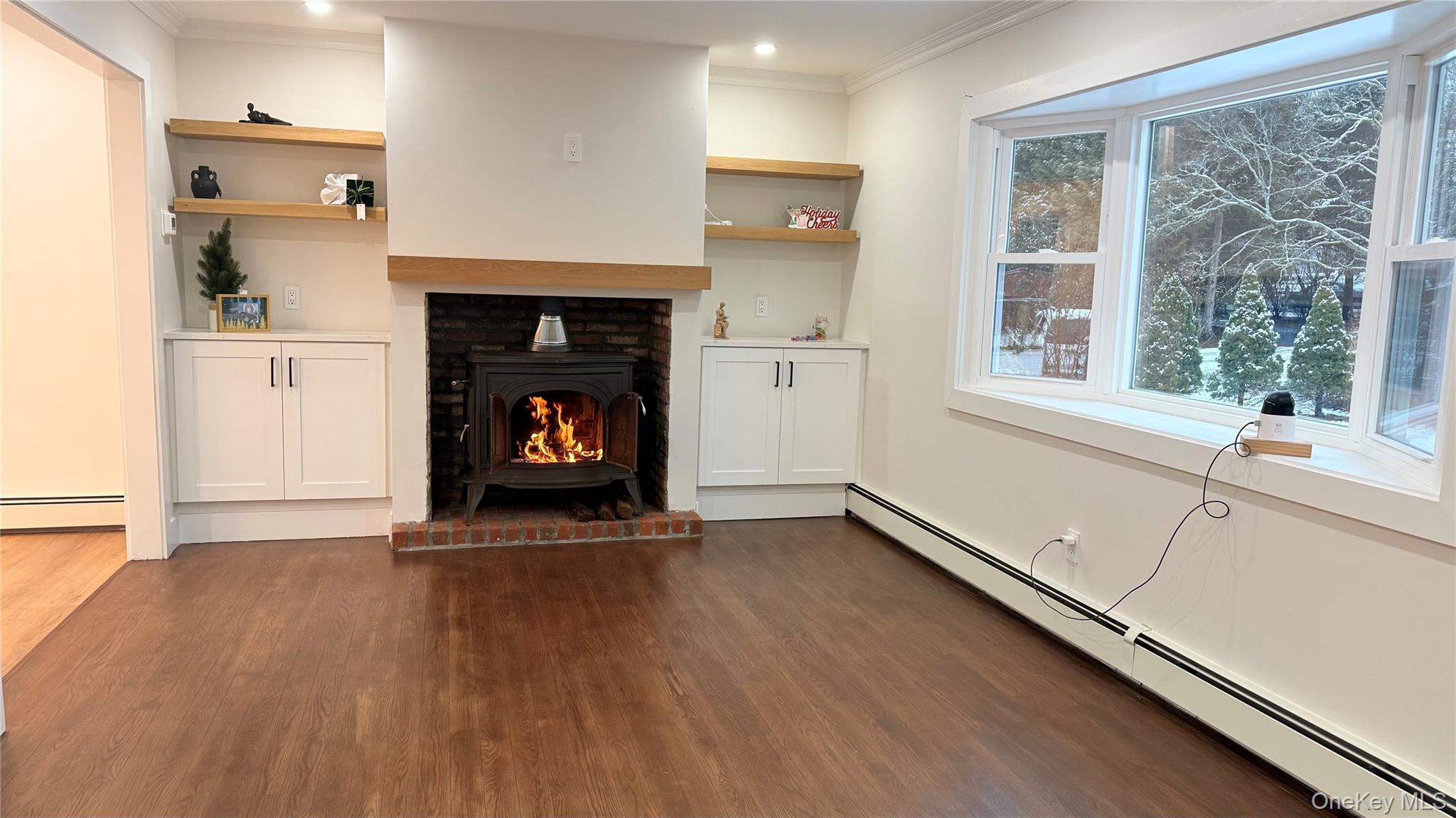 94 Sally Lane Ridge, NY 11961 - Photo 5 of 17 a view of an empty room and a fireplace with wooden floor