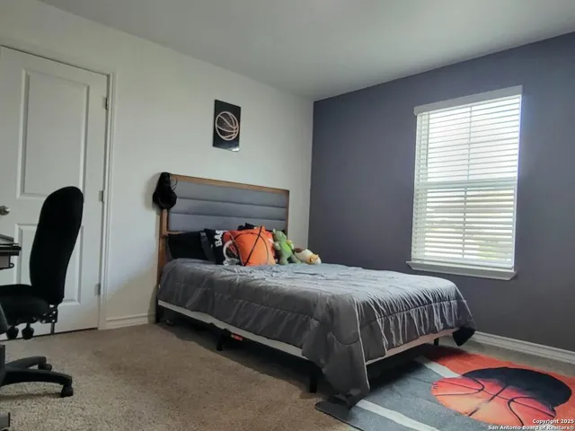 a bedroom with a bed a desk and chair