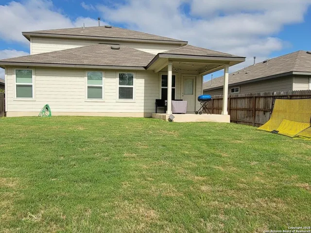 a view of a house with a backyard