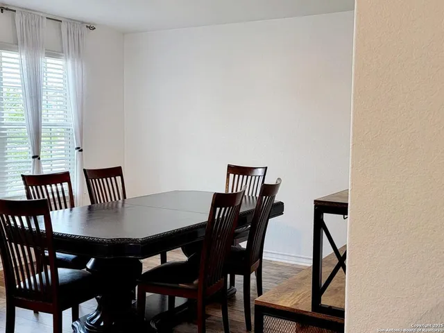 a view of a dining room with furniture and window