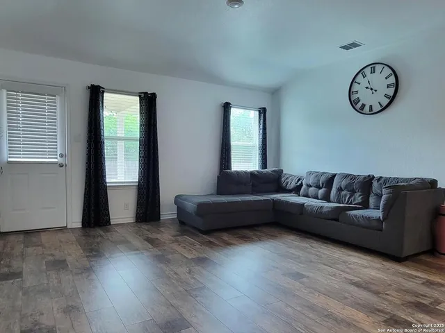 a living room with couch and a large window