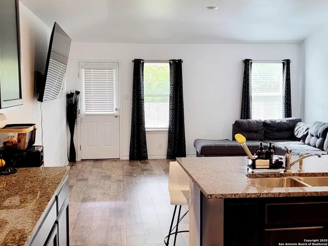 a kitchen with granite countertop a sink and a stove