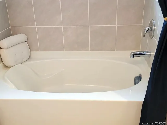 a bathroom with a bath tub