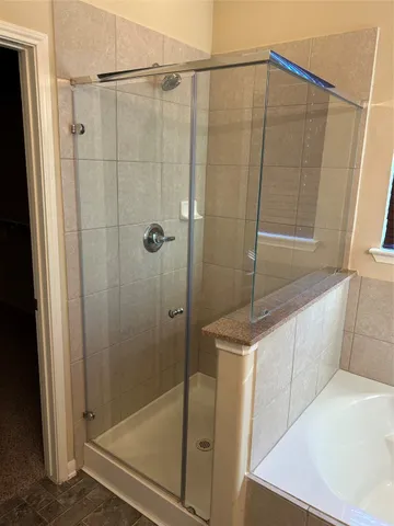 a bathroom with a shower and a sink