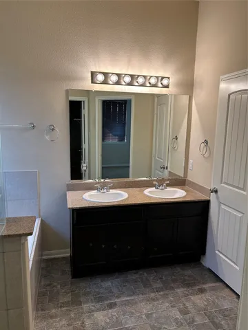 a bathroom with a sink and mirror