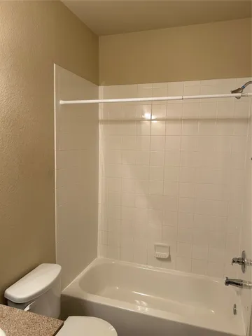 a bathroom with a shower and a toilet