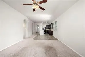 a view of a kitchen with furniture and a ceiling fan