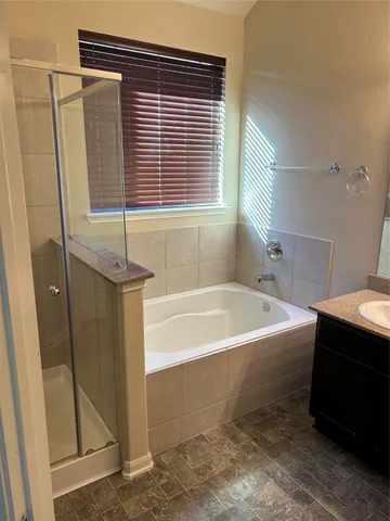 a bathroom with a bathtub and a shower