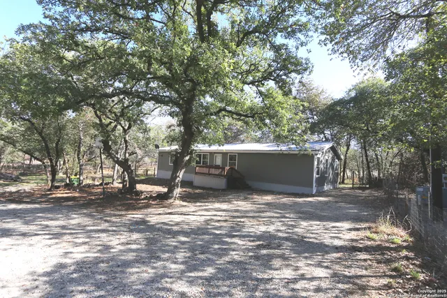 a view of a wooden deck next to a yard