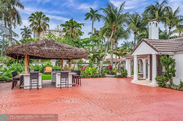 a patio with a table and chairs under an umbrella