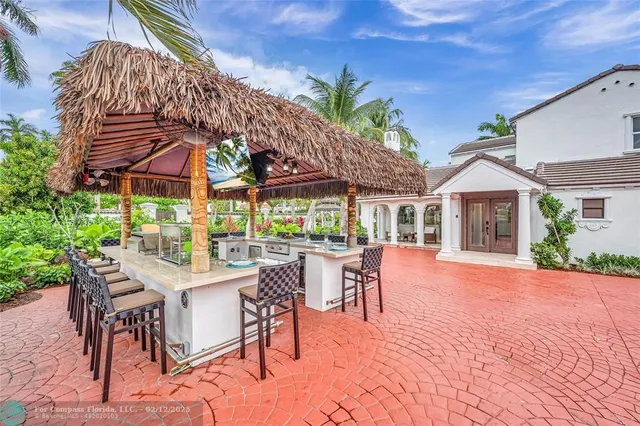 a view of a patio with a table chairs and a backyard