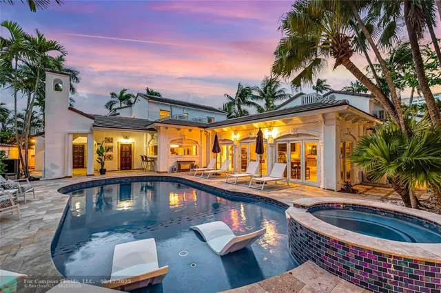 a view of swimming pool with a lounge chairs