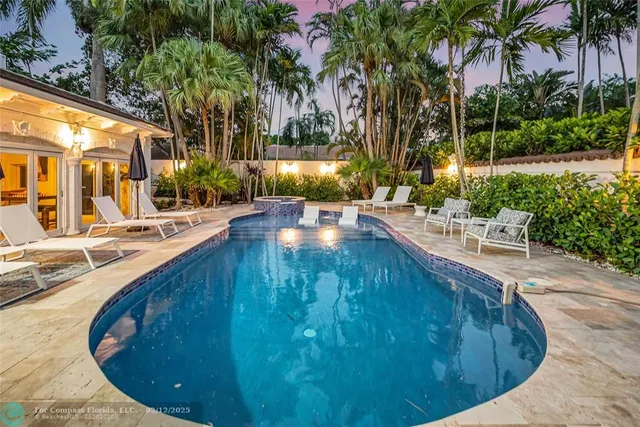 a front view of a house with a yard and potted plants