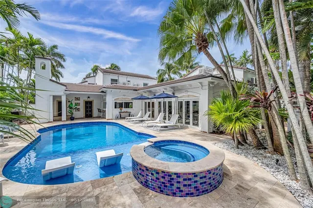 a view of a dining room with furniture a chandelier and wooden floor
