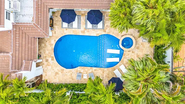a view of an house with backyard and sitting area