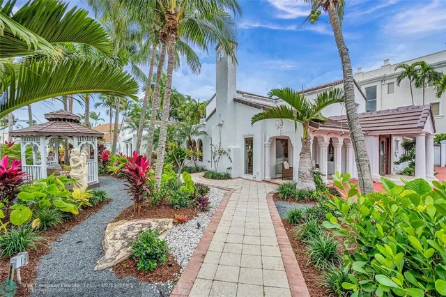 a view of an house with backyard and sitting area