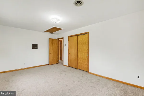 an empty room with a empty space and windows