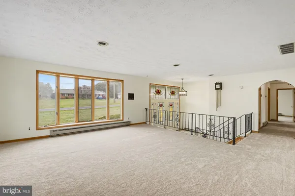 a view of an empty room with windows