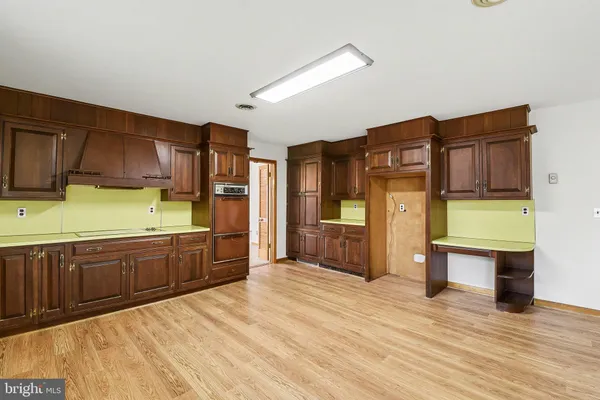 a large kitchen with stainless steel appliances kitchen island granite countertop a refrigerator stove and oven