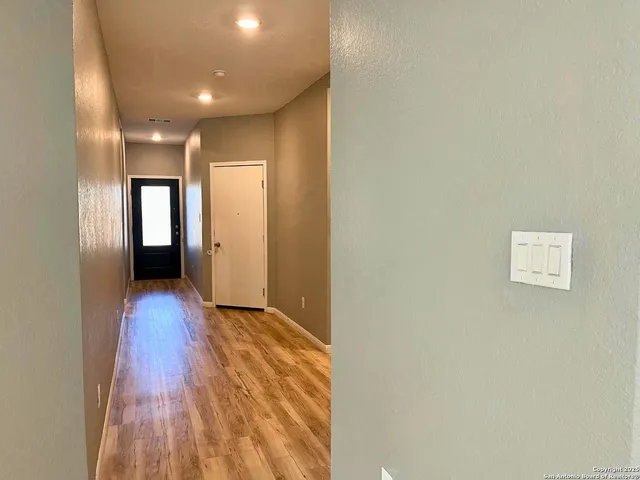 a view of gallery with wooden floor