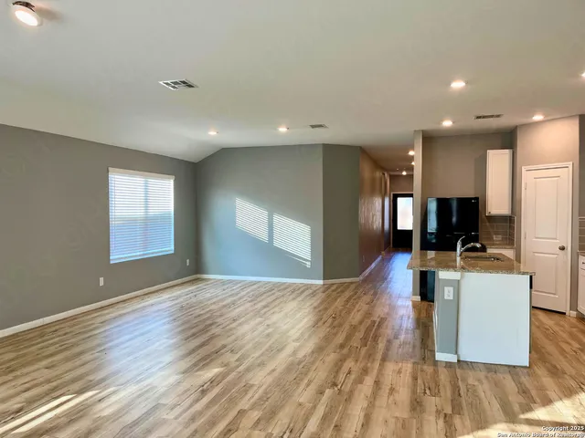 a view of kitchen with cabinets and wooden floor