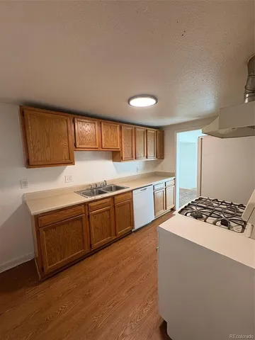 a kitchen with stainless steel appliances granite countertop a sink stove and cabinets
