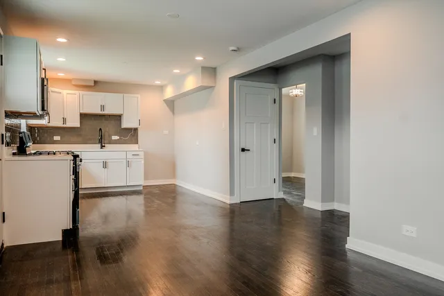a view of a kitchen with a sink and a refrigerator