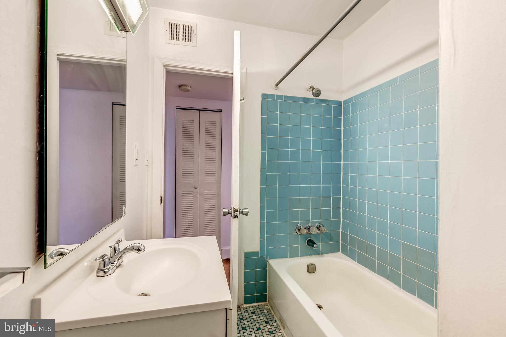 3060 16th Street Northwest, Unit 308 Washington, DC 20009 - Photo 16 of 21 a bathroom with a tub a sink and a mirror