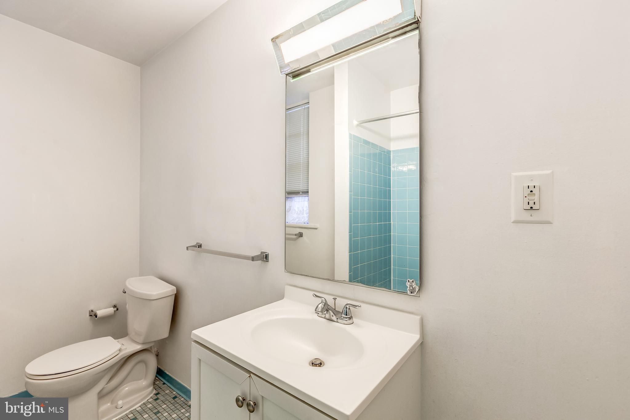 3060 16th Street Northwest, Unit 308 Washington, DC 20009 - Photo 17 of 21 a white toilet sitting next to a bathroom sink
