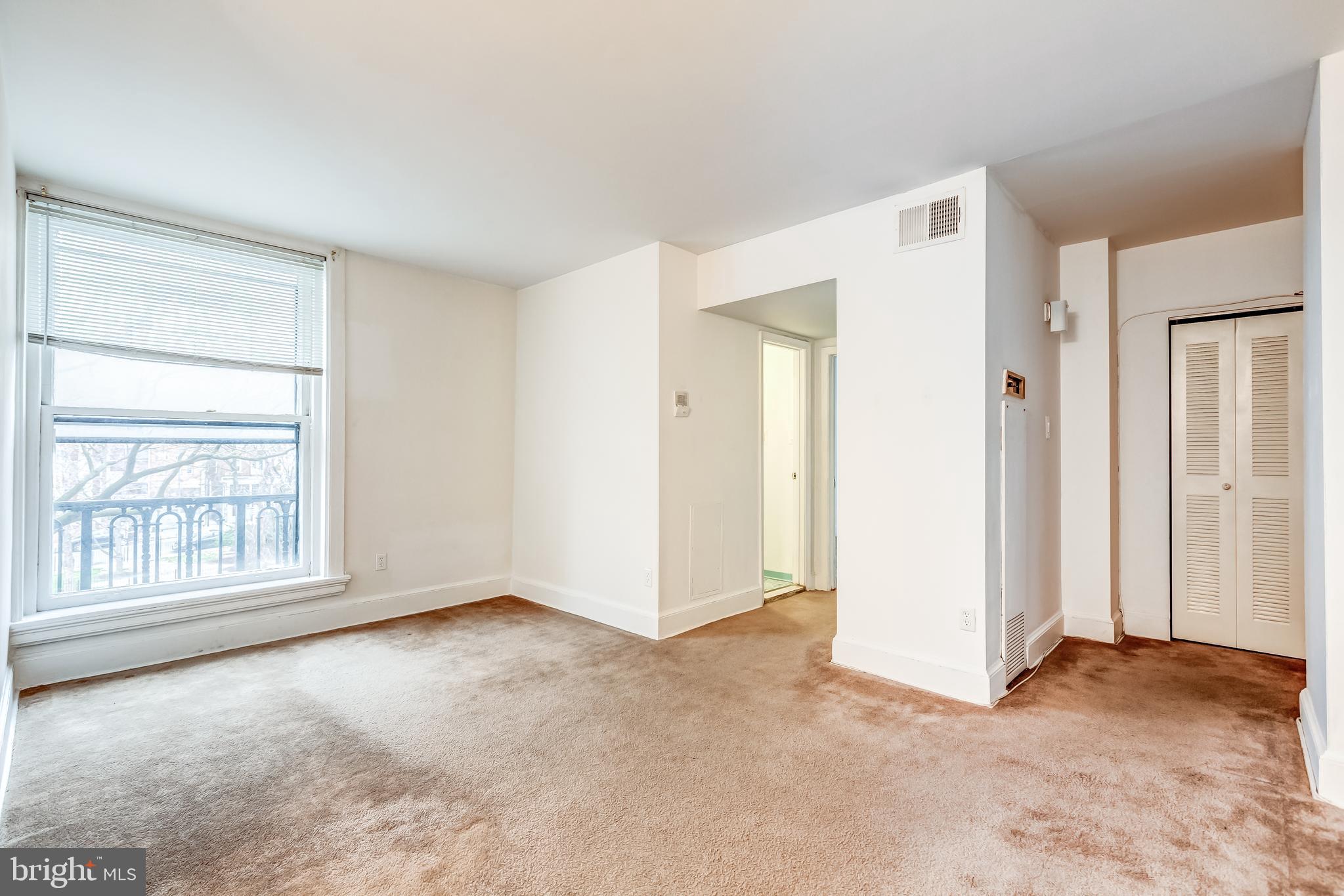 3060 16th Street Northwest, Unit 308 Washington, DC 20009 - Photo 5 of 21 an empty room with windows and closet