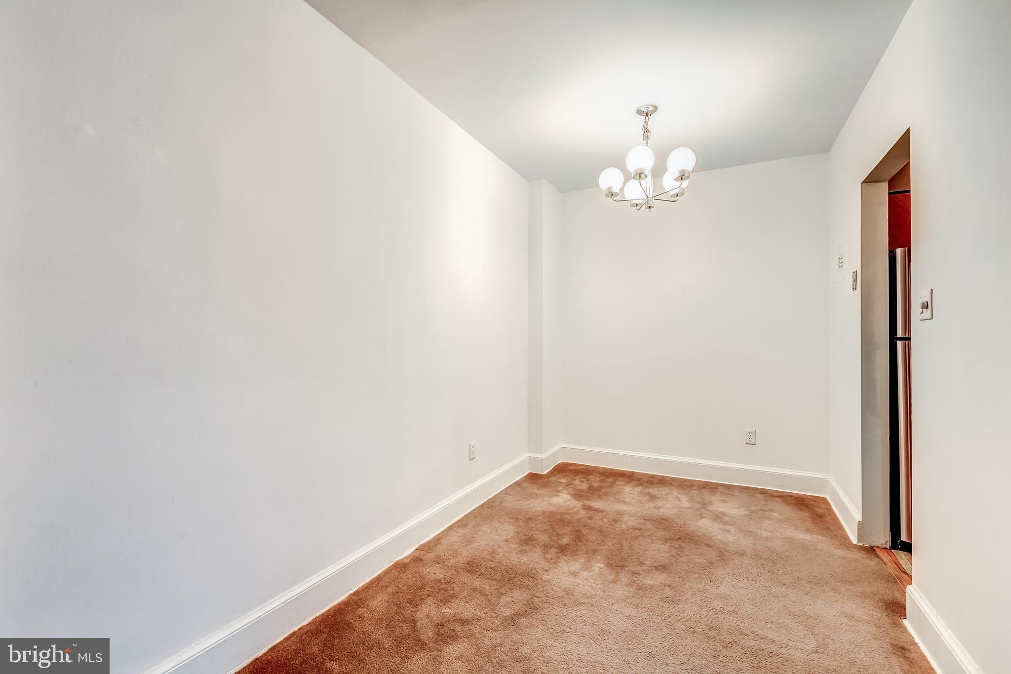 3060 16th Street Northwest, Unit 308 Washington, DC 20009 - Photo 7 of 21 an empty room with a chandelier fan