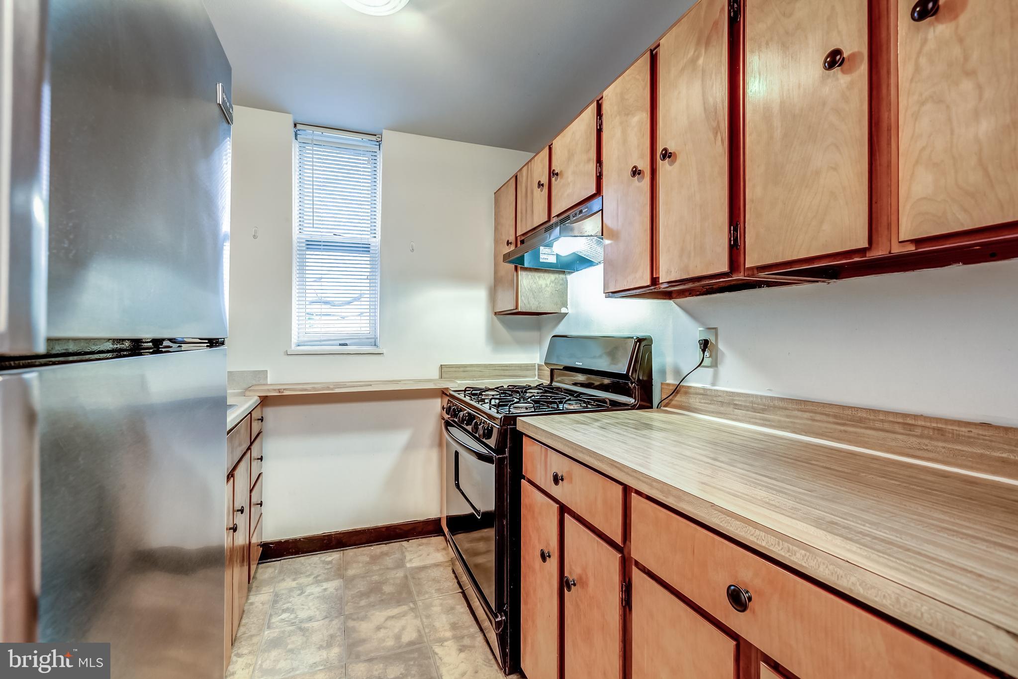 3060 16th Street Northwest, Unit 308 Washington, DC 20009 - Photo 9 of 21 a kitchen with stainless steel appliances granite countertop a sink and a cabinets