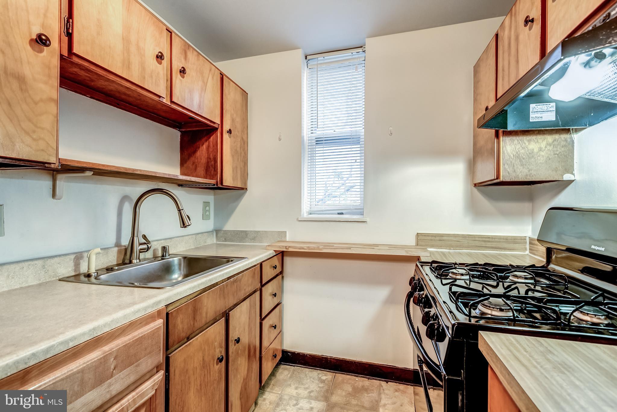 3060 16th Street Northwest, Unit 308 Washington, DC 20009 - Photo 10 of 21 a kitchen with stainless steel appliances granite countertop a sink stove and cabinets