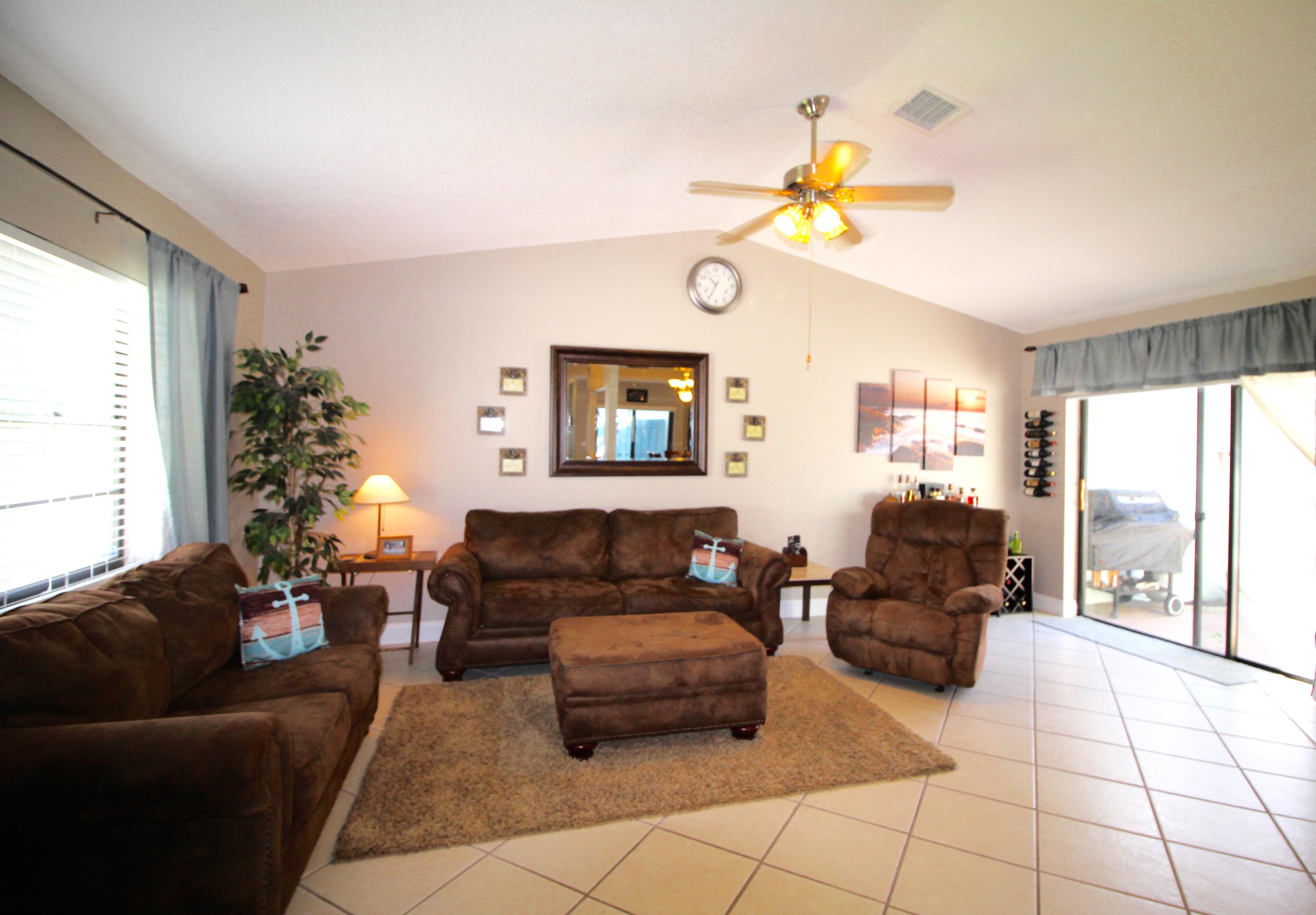 9124 Southwest 22nd Street, Unit F Boca Raton, FL 33428 - Photo 6 of 19 a living room with furniture and a large window