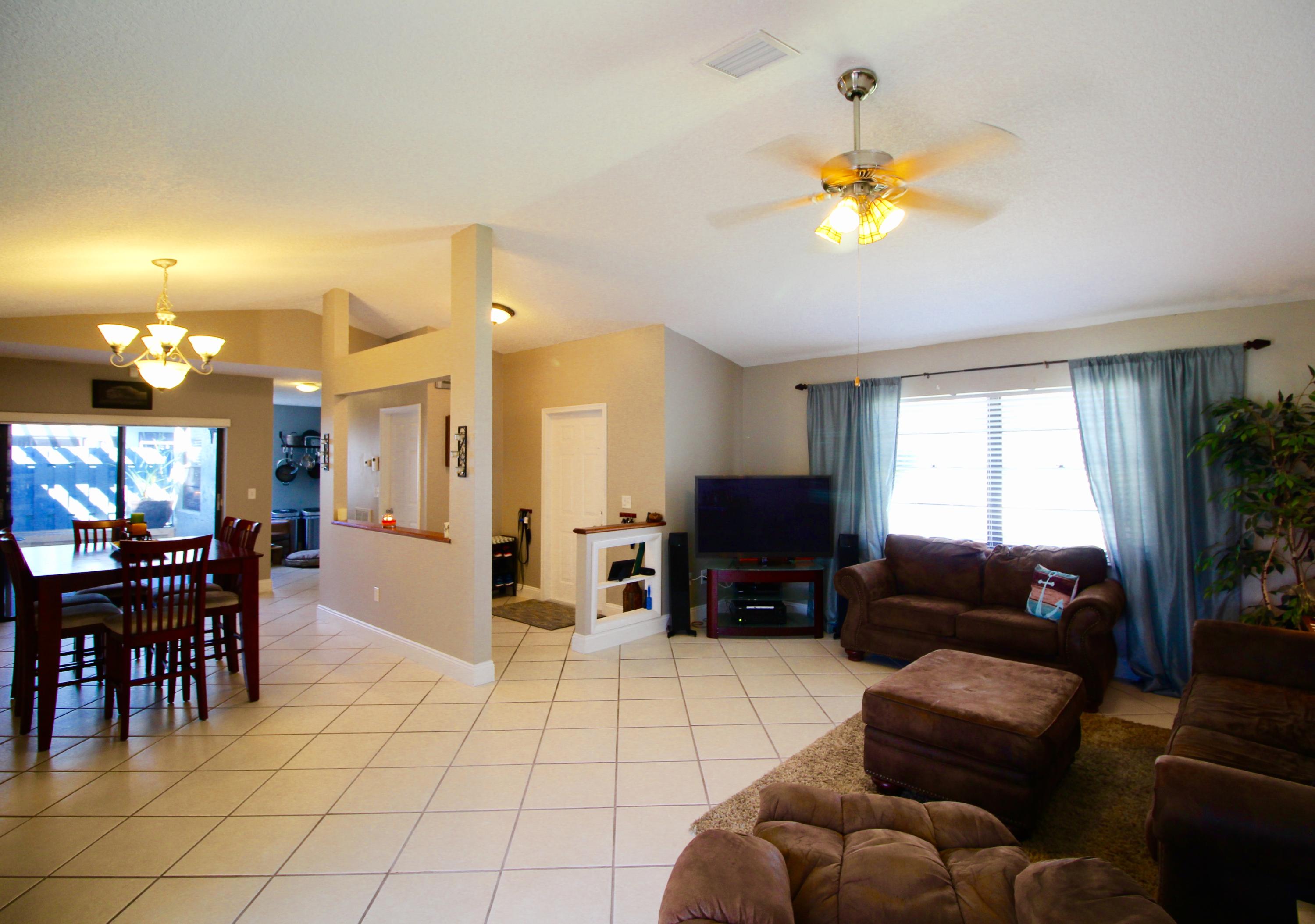 9124 Southwest 22nd Street, Unit F Boca Raton, FL 33428 - Photo 7 of 19 a living room with furniture a dining table and a fireplace