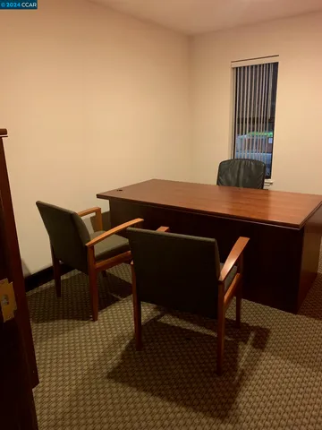 a view of a workspace with furniture