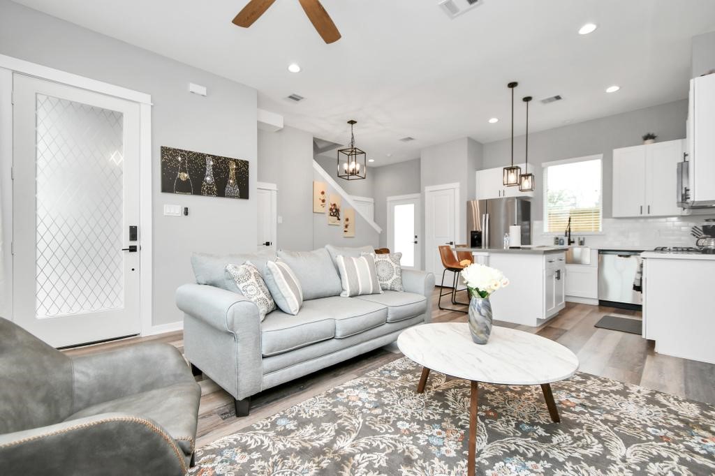 407 Stonework Oaks Lane Houston, TX 77076 - Photo 1 of 34 a living room with furniture and a chandelier