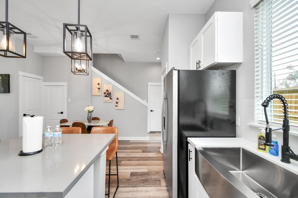 407 Stonework Oaks Lane Houston, TX 77076 - Photo 12 of 34 a kitchen view with granite countertop a refrigerator and a sink